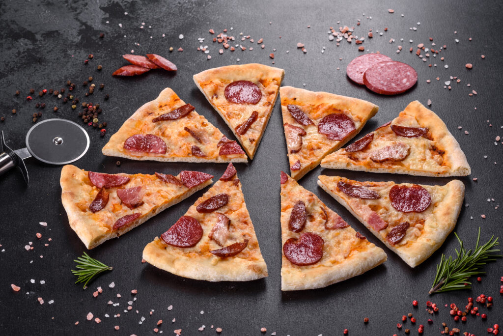 Fresh delicious pizza made in a hearth oven with four types of meat and sausage. Mediterranean cuisine